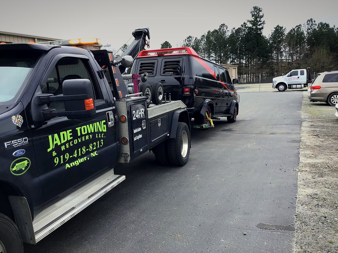 Jade Towing F-550 wrecker towing a van in Angier, NC